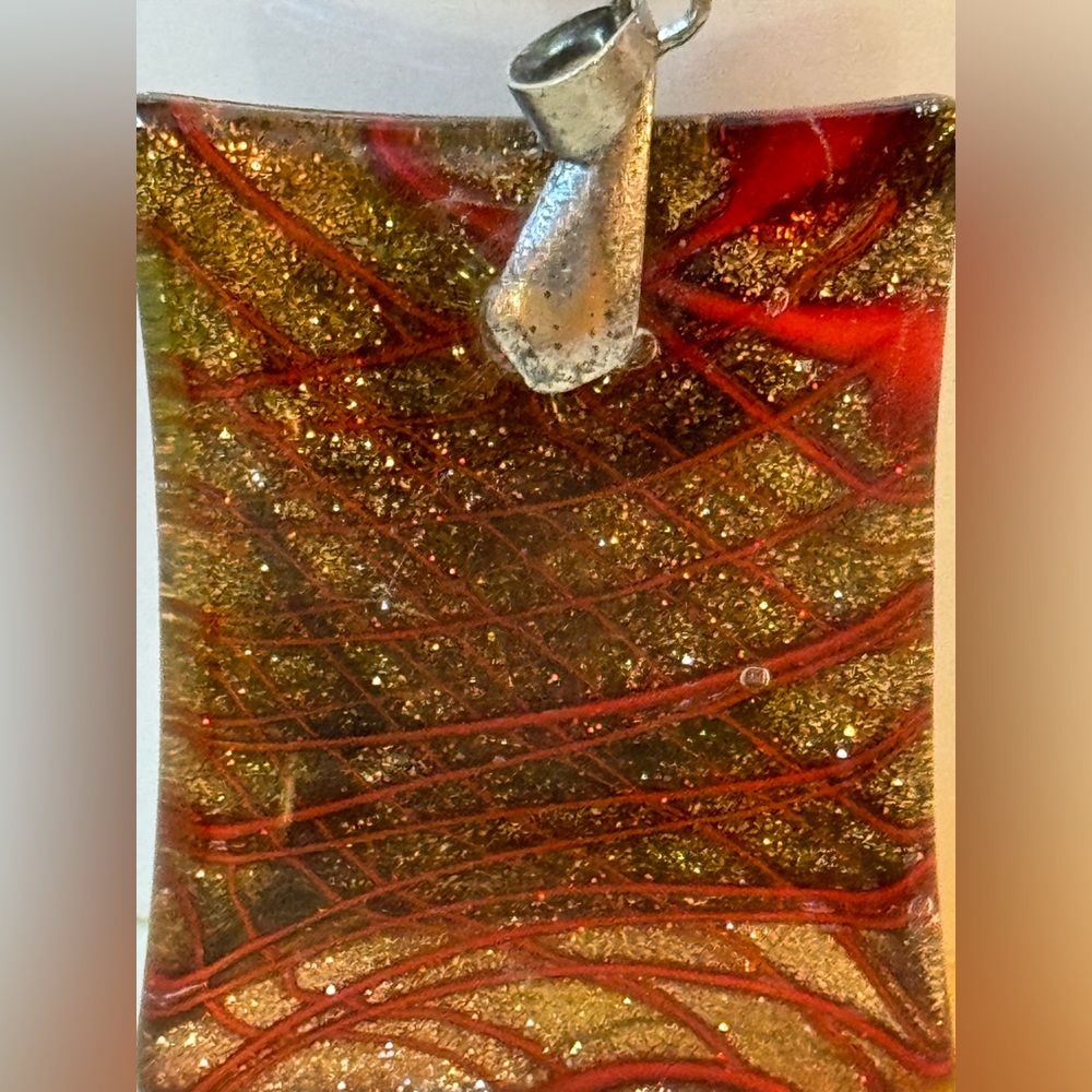 Pendant glass art deco gold & red w/the back being gold glitter only 1.75” x 1.5